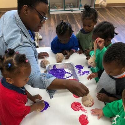 An Orlando Day Nursery teacher instructing her classroom into a fun and education project